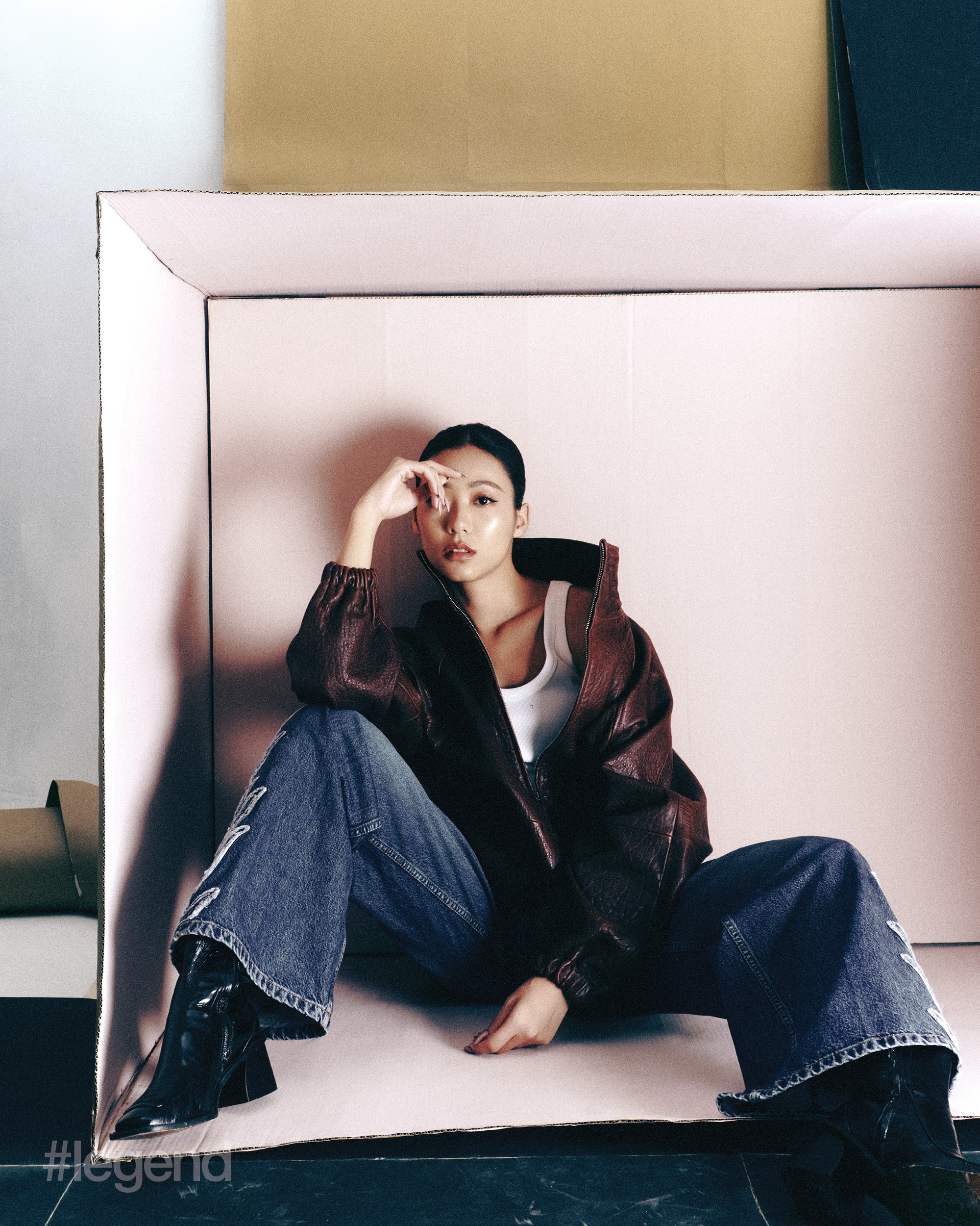 Burgundy leather jacket, white vest top with rhinestone detail, blue flared jeans and black ankle boots _ Sandro