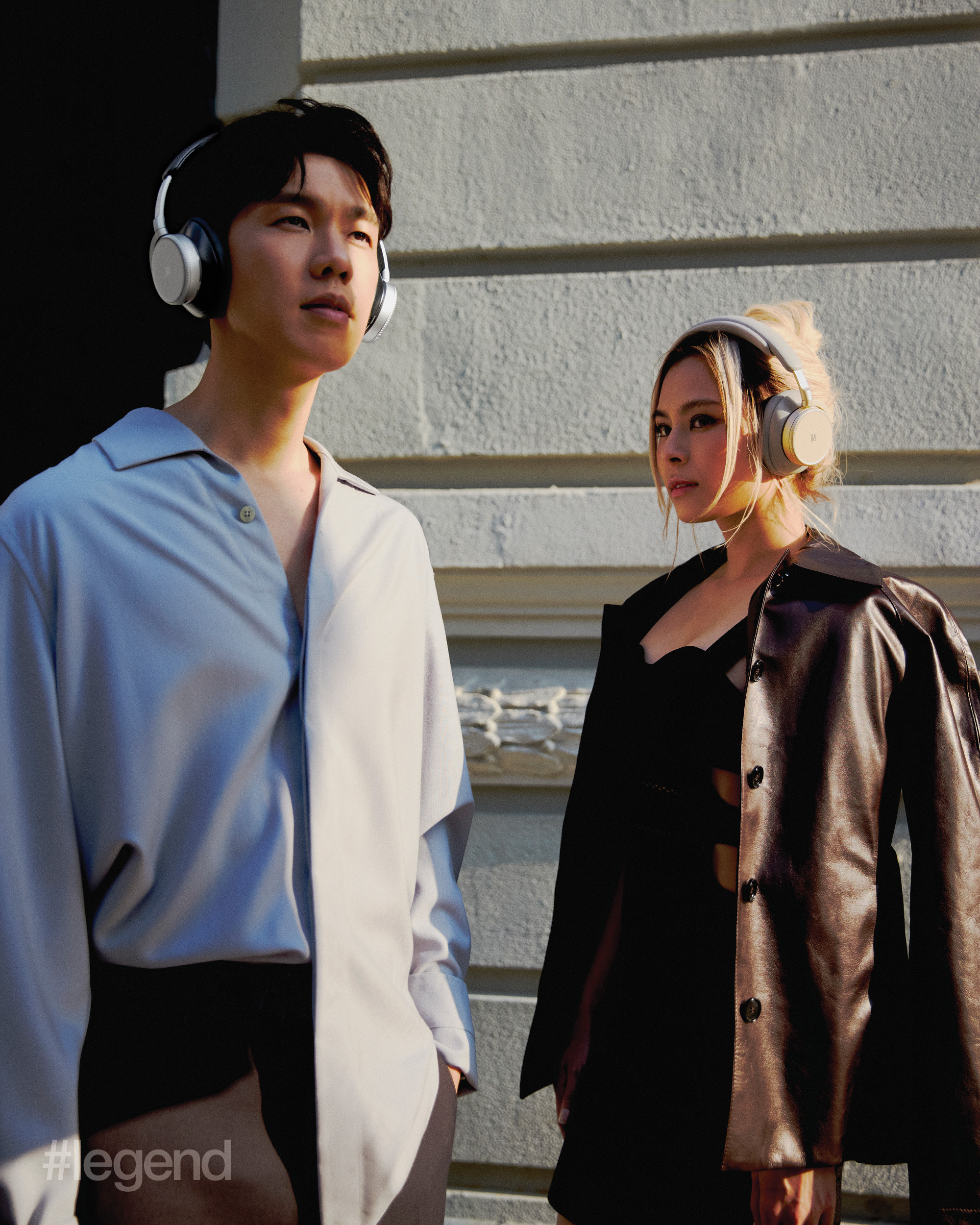 Phil Lam wears light blue oversized shirts; dark grey wide leg high waist trousers _ Zegna. Gin Lee wears dark brown leather jacket with belts details _ Ports1961 and black cut out designed dress _ Tom Ford. Artists wear Bang & Olufsen Beoplay H100