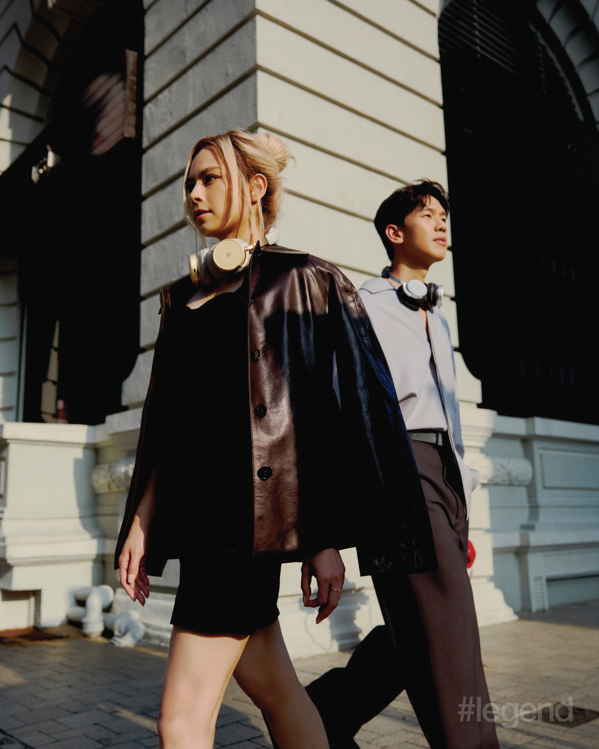 Phil Lam wears light blue oversized shirts; dark grey wide leg high waist trousers _ Zegna. Gin Lee wears dark brown leather jacket with belts details _ Ports1961 and black cut out designed dress _ Tom Ford. Artists wear Bang & Olufsen Beoplay H100