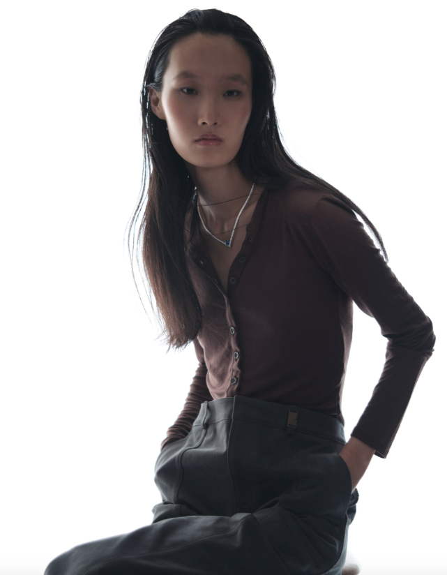 Necklace _ Chaumet; Brown bodysuit _ Agolde; Black trousers _ Burberry