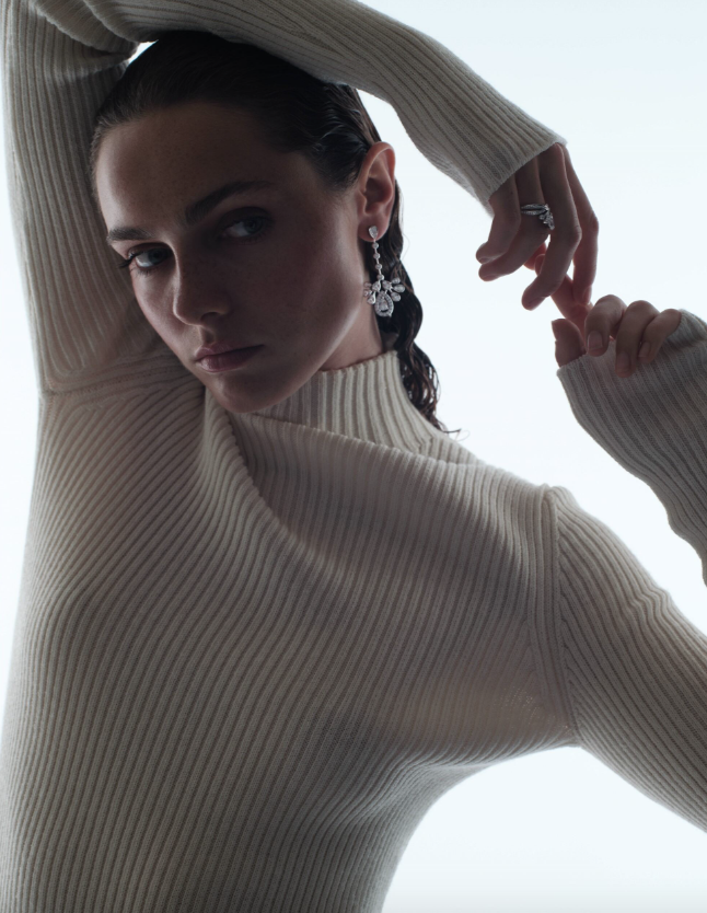 Earrings and ring _ Chaumet; Cream long-sleeve dress and black heeled boots _ Chanel