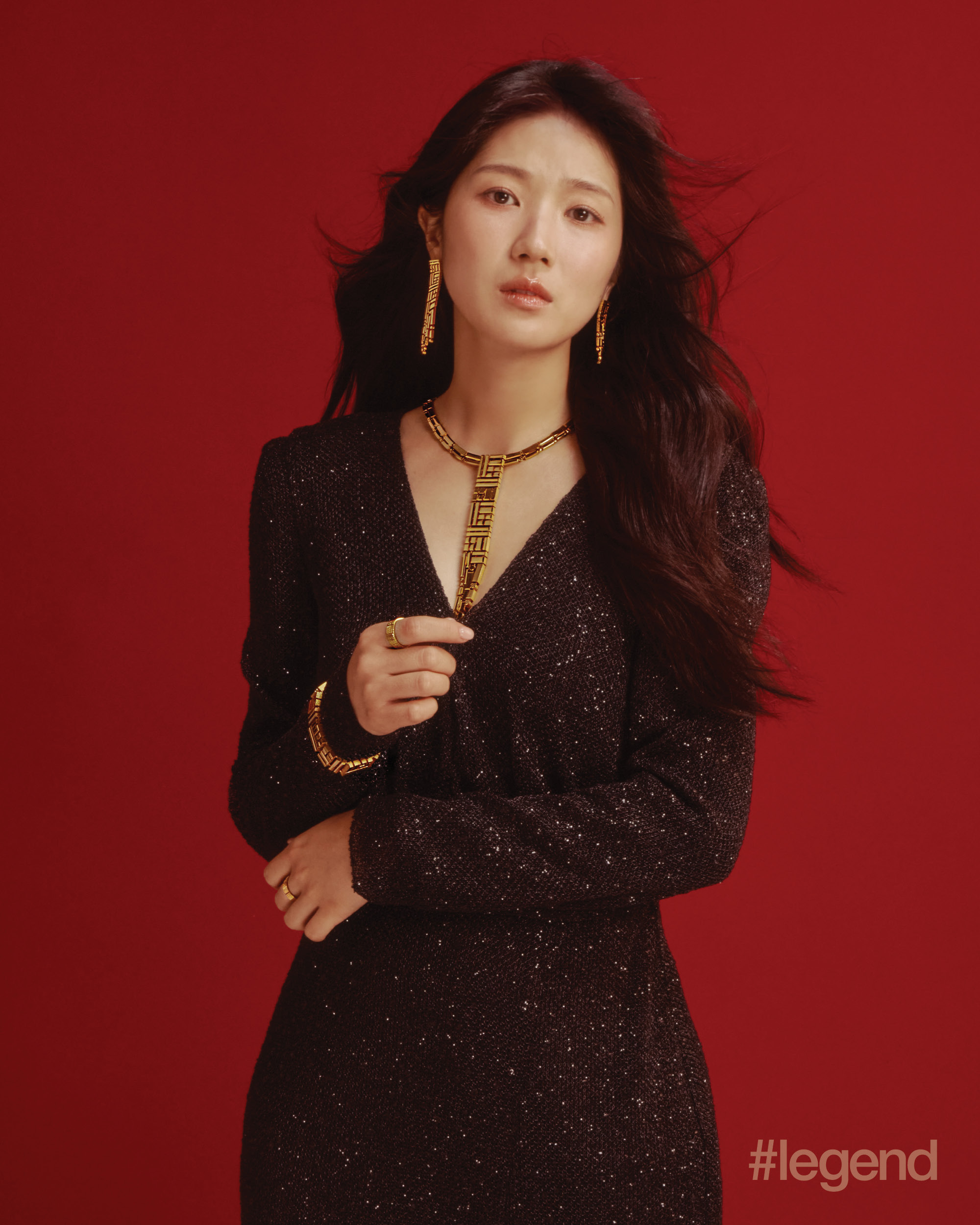 Black long-sleeve dress with metallic thread _ Elysian Bridal Couture; Rouge Collection earrings, necklace, bangle and rings in pure gold _ Chow Tai Fook