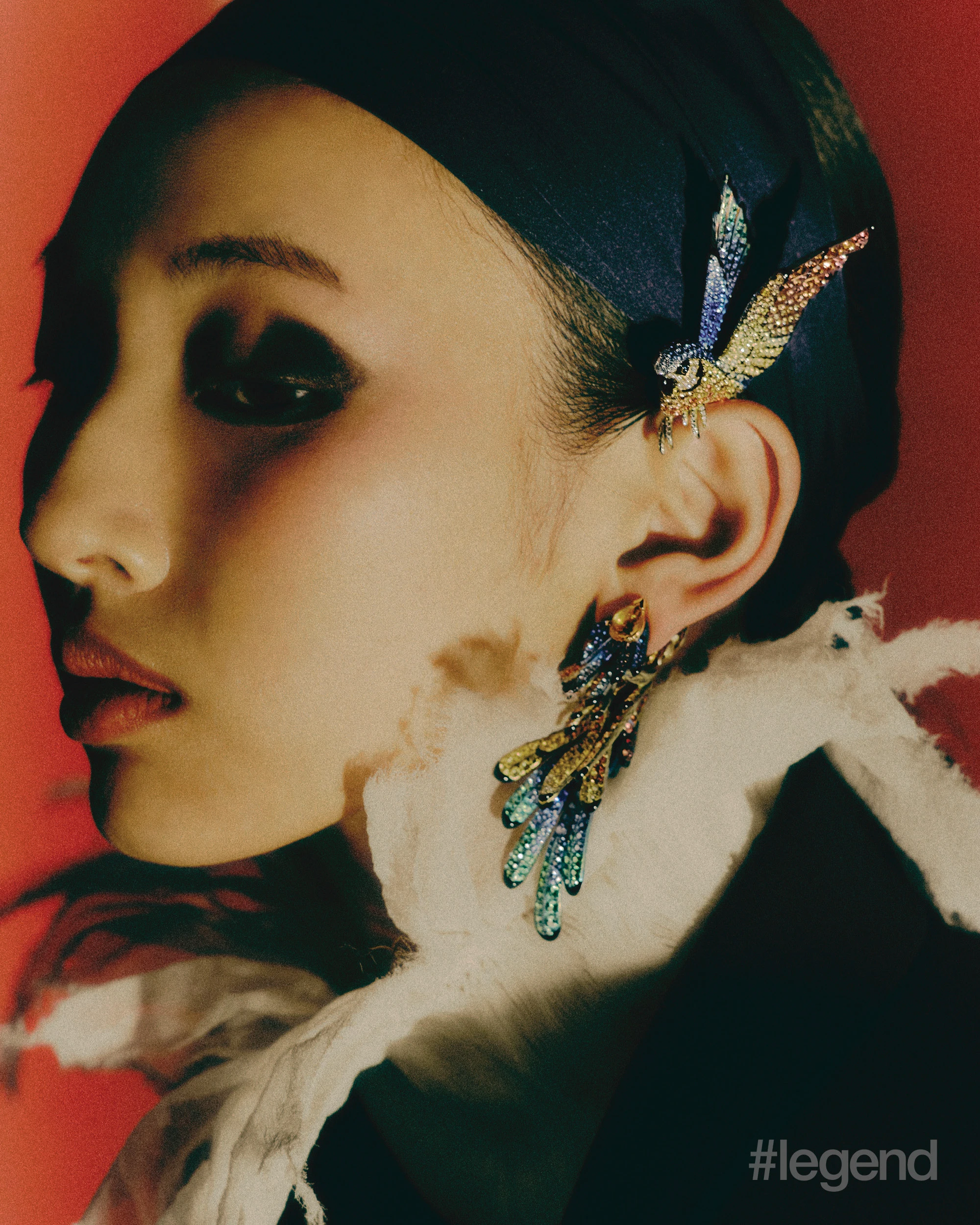 Nuri Pendant earrings _ Boucheron; Ivory fringed collar blouse and navy coat _ McQueen.