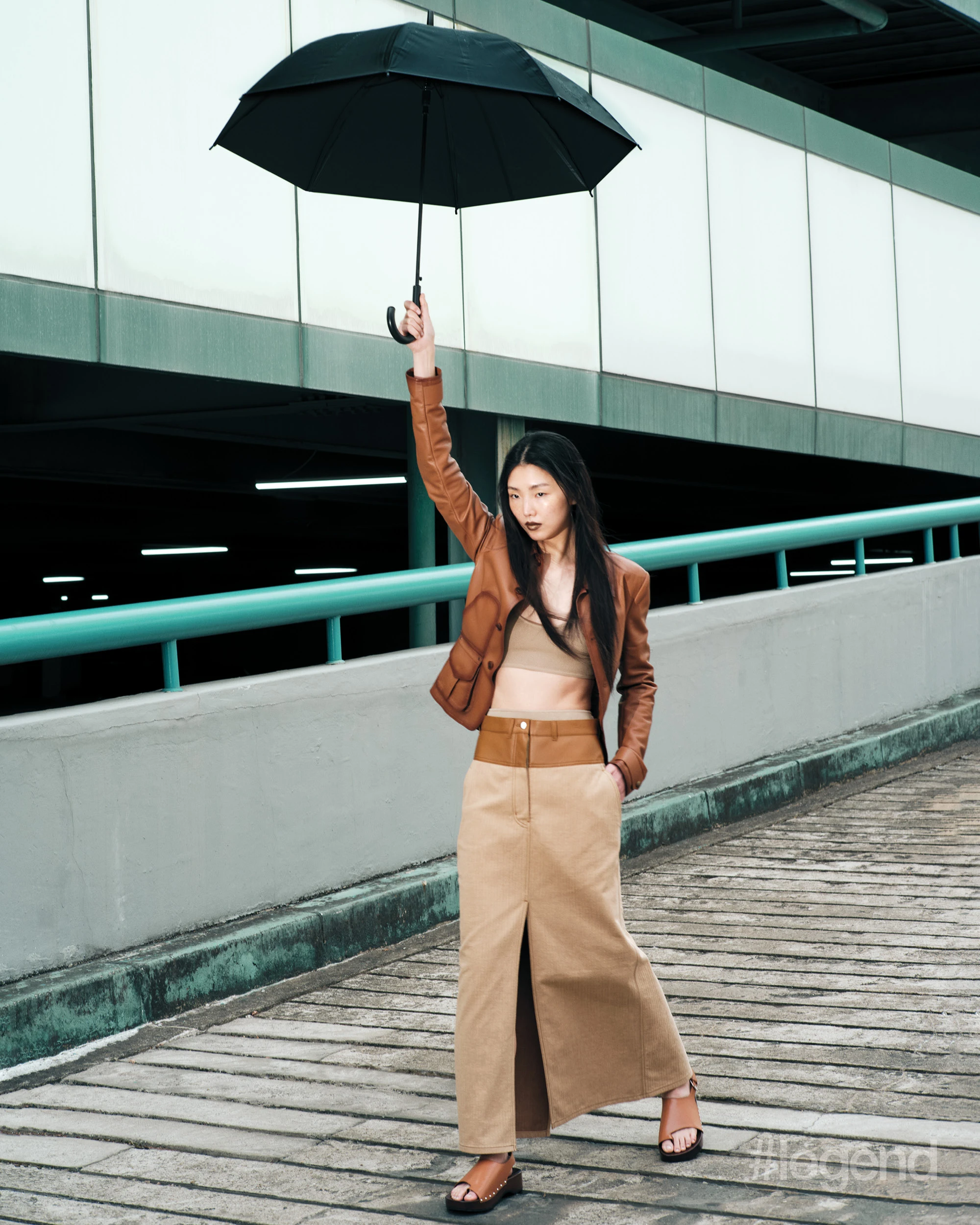Brown leather jacket _ Ralph Lauren; Beige bra, briefs and skirt, and brown slides _ Hermès