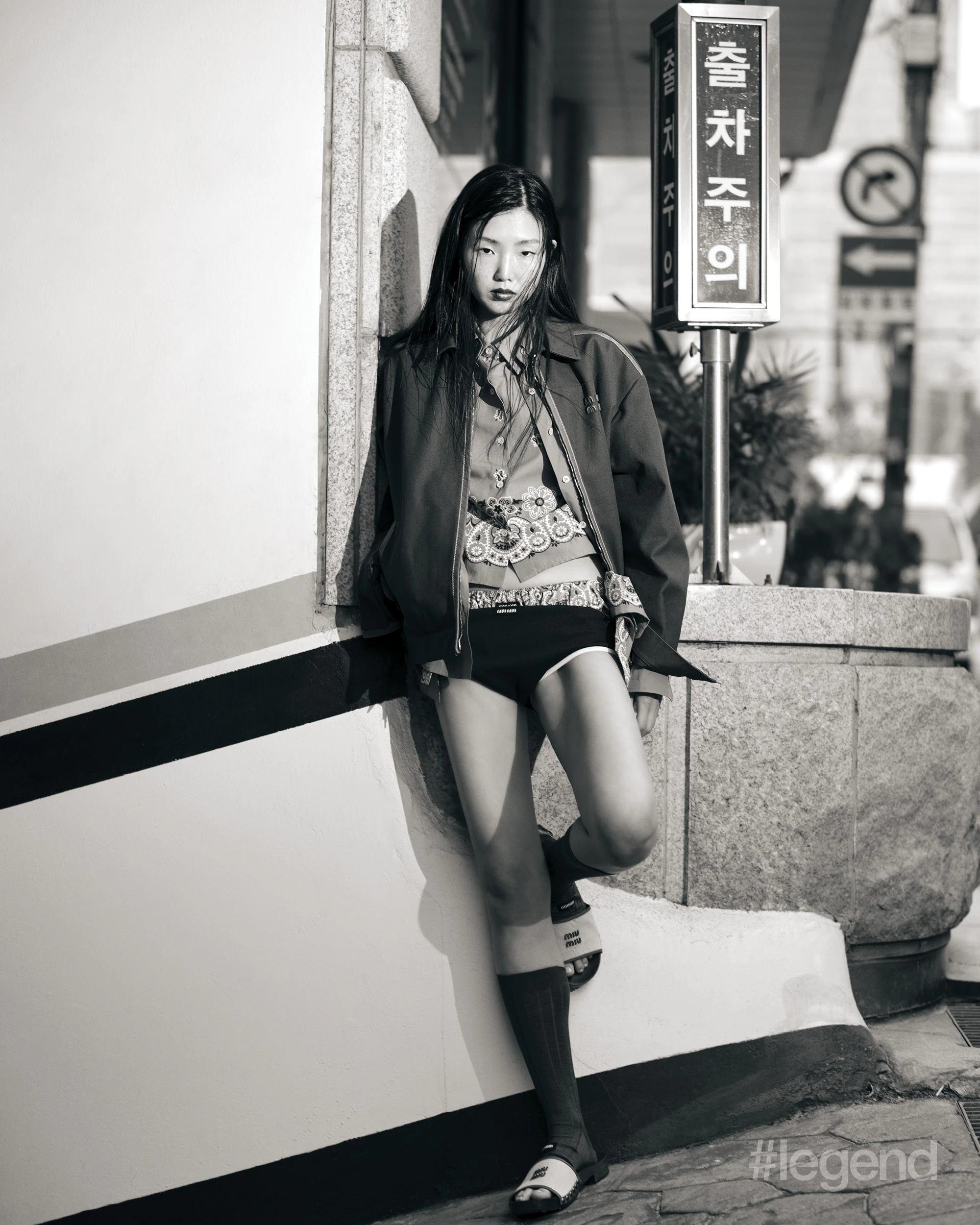 Brown jacket, blue paisley short-sleeve shirt and briefs, blue long-sleeve shirt, black briefs, grey socks and leather clogs _ Miu Miu