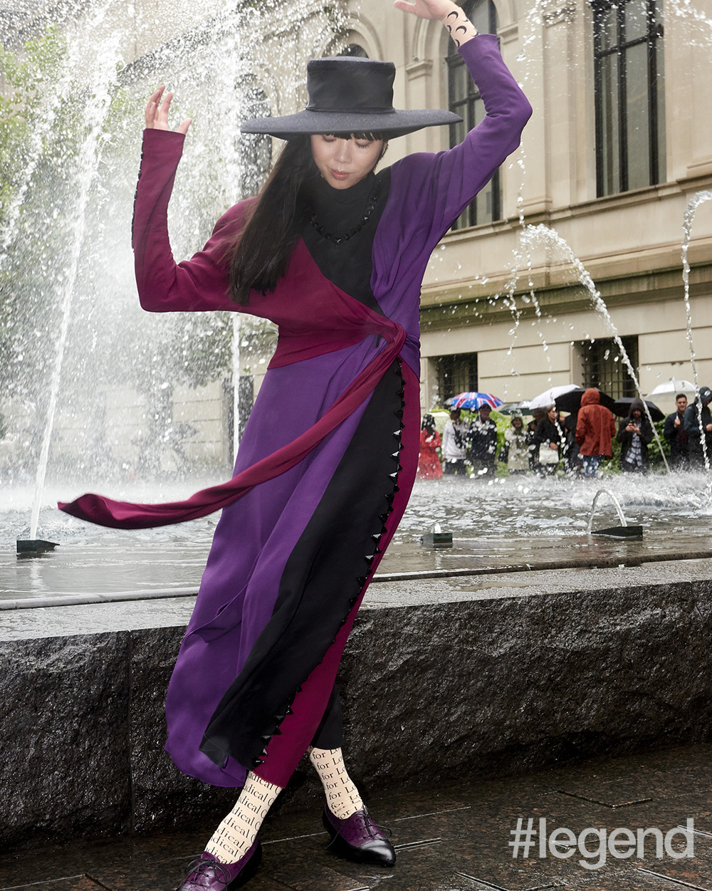 Black hat by Stephen Jones for Marc Jacobs, tricoloured dress and bicoloured Oxfords by Marc Jacobs and leggings and bodysuit by Marine Serre